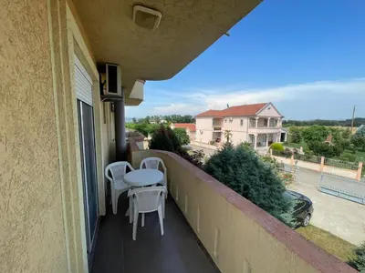 a balcony with a table and chairs and a view at Mali Medved Ulcinj in Ulcinj