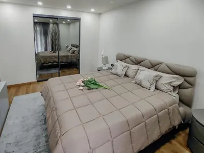 a bedroom with a large bed with flowers on it at The Luxury Maison W Nest - 2 bedroom apartment in Kotor