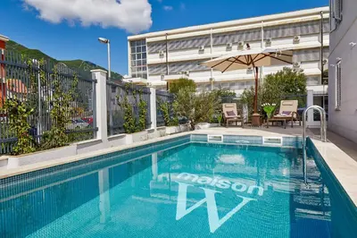 a swimming pool on the side of a building at The Luxury Maison W Nest - 2 bedroom apartment in Kotor