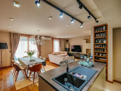 a kitchen and living room with a couch and a table at The Luxury Maison W Nest - 2 bedroom apartment in Kotor