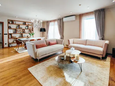 a living room with two couches and a table at The Luxury Maison W Nest - 2 bedroom apartment in Kotor