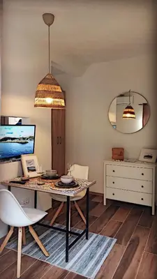 a dining room with a table and two chairs at Bonaca Apartments in Budva