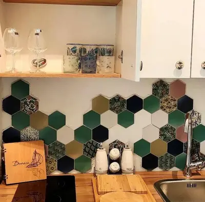 a kitchen with black and white tiles on the wall at Bonaca Apartments in Budva