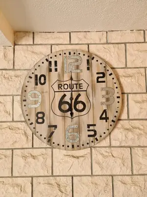 a clock on the side of a brick wall at Beatrix Suites in Budva
