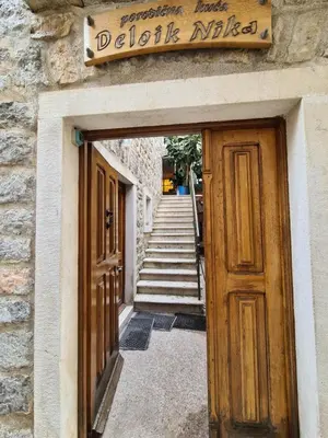 a door to a building with a sign on it at Beatrix Suites in Budva