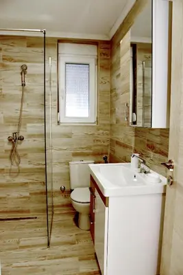 a bathroom with a toilet and a sink and a shower at Sunset Apartments in Kotor