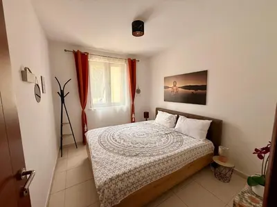 a bedroom with a bed and a window at Apartment 