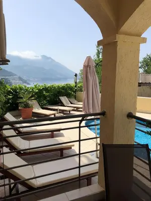 a row of chaise lounge chairs on a balcony with a pool at Apartment 