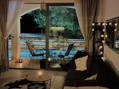 a living room with a couch and a view of a pool at Apartment 