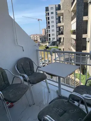 a table and chairs on the balcony of a building at Apartment Lena, Budva Centar in Budva