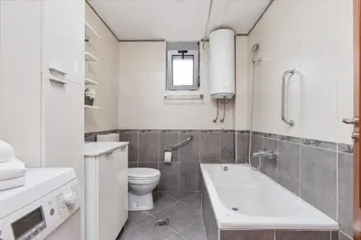 a bathroom with a toilet and a tub and a sink at Ana's Place Near the Sea in Kotor