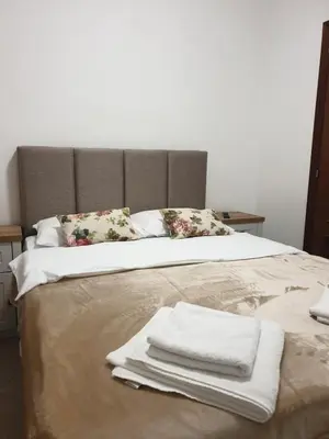 a bed with towels and pillows on top of it at Ana's Place Near the Sea in Kotor