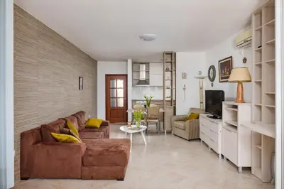 a living room with a couch and a tv at Ana's Place Near the Sea in Kotor
