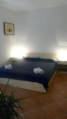 a bedroom with a bed with two towels on it at Guest house Živković in Sveti Stefan