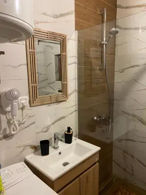 a bathroom with a sink and a shower at Guest House Mare in Bar