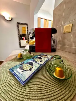 a table with glasses and plates on top of it at Studio apartmani Ljubica in Budva