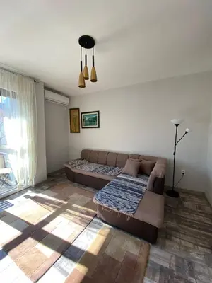 a living room with a couch and a bed at Apartmani Vila in Cetinje