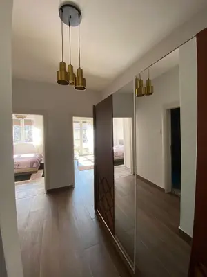 a hallway with a large mirror and a room at Apartmani Vila in Cetinje