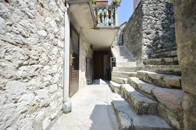 an alley with stairs and a door in a stone building at Apartment Amigo Old Town Kotor in Kotor