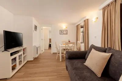 a living room with a couch and a television at Apartment Amigo Old Town Kotor in Kotor