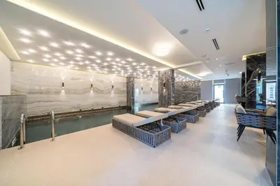 a waiting room with a row of benches in a museum at Hotel Millennium by Aycon in Budva