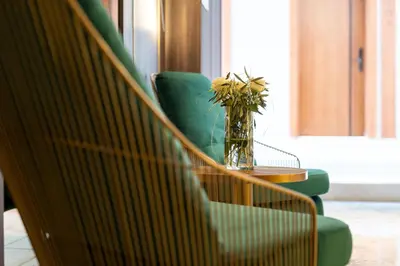 a vase with flowers on a table in a room at Hotel Millennium by Aycon in Budva