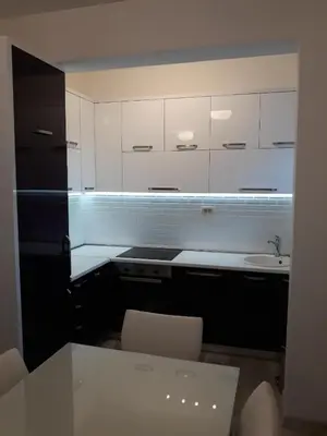 a kitchen with white cabinets and a sink at Apartman Pejovic in Petrovac na Moru
