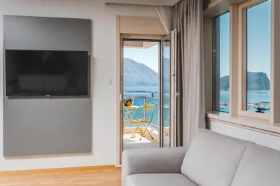 a living room with a couch and a large window at Fontana Residence Budva in Budva