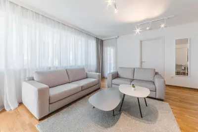 a living room with a couch and a table at Fontana Residence Budva in Budva