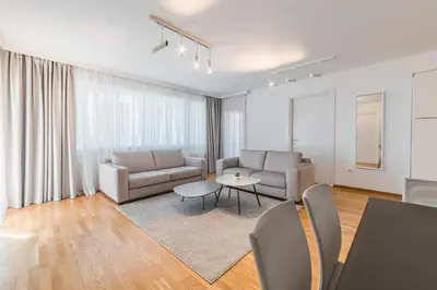 a living room with a couch and a table at Fontana Residence Budva in Budva