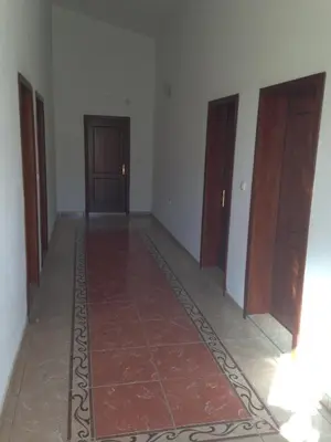 a hallway with three doors and a tile floor at Niki Apartments in Ulcinj