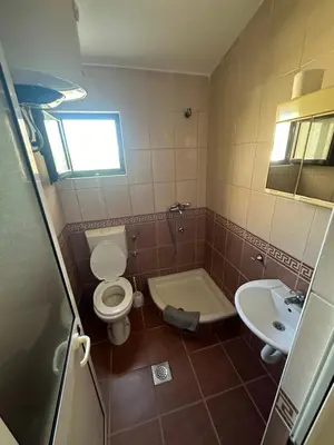 a bathroom with a toilet and a sink at Niki Apartments in Ulcinj