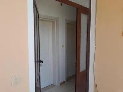 a hallway with a mirror and a door at Niki Apartments in Ulcinj