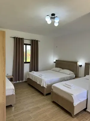 a hotel room with two beds and a window at Niki Apartments in Ulcinj