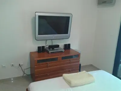 a tv sitting on top of a wooden dresser at Stan Inlav Pržno in Pržno
