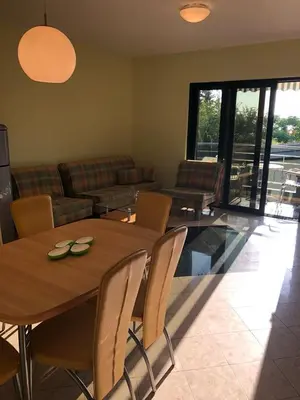 a living room with a wooden table and chairs at Stan Inlav Pržno in Pržno