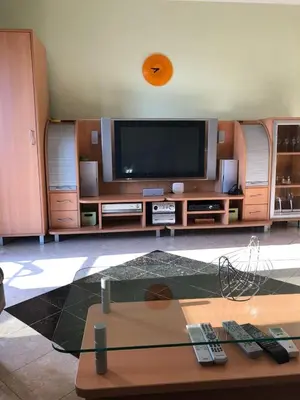 a living room with a tv and a table at Stan Inlav Pržno in Pržno