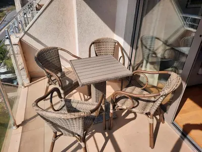 a table and chairs sitting on a balcony at Luxury apartment near beach in Pržno