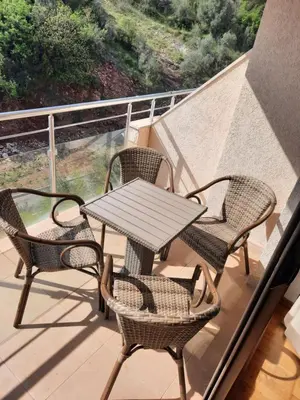 a table and four chairs on a balcony at Luxury apartment near beach in Pržno