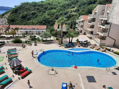 an overhead view of a swimming pool in a resort at Luxury apartment near beach in Pržno