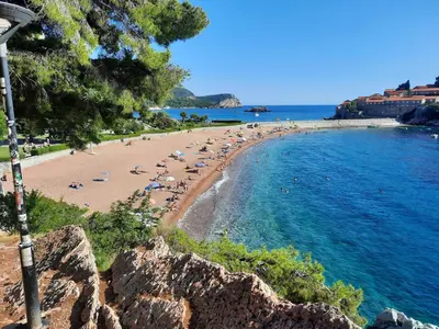 a beach with a bunch of people laying on the beach at Luxury apartment near beach in Pržno