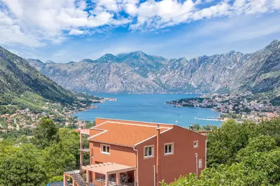 a house with a view of a lake and mountains at Apartment Petar 2 in Kotor