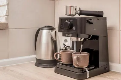 a coffee machine sitting on a counter with two cups at Apartment Petar 2 in Kotor