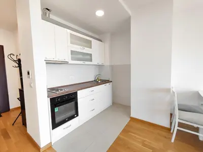 a kitchen with white cabinets and a stove top oven at Sea view apartment in Becici in Budva