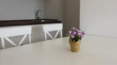 a vase of flowers sitting on a counter in a kitchen at Sea view apartment in Becici in Budva