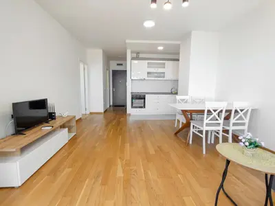 a living room with a kitchen and a dining room at Sea view apartment in Becici in Budva