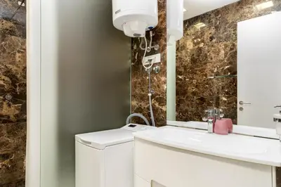 a bathroom with a sink and a mirror at Tre Canne Red Bull in Budva