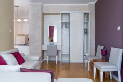 a living room with a white couch and a table at Tre Canne Red Bull in Budva