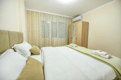a bedroom with two white towels on a bed at Apartman Centar 2 in Podgorica