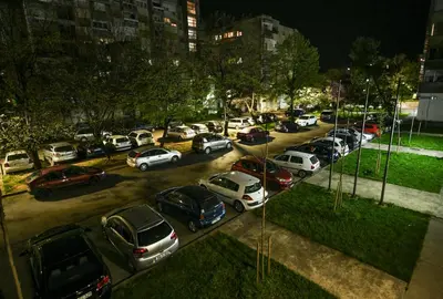 a bunch of cars parked in a parking lot at night at Apartman Centar 2 in Podgorica